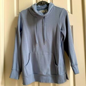 Powder blue cowl neck top with kangaroo pocket. Split detail at hem